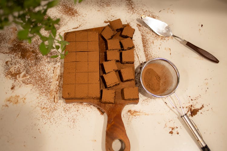 Chocolate Brownie With Cocoa Powder On White Table