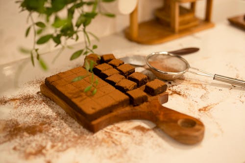 Free Chocolate Brownie on Wooden Chopping Board on White Table Stock Photo