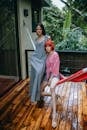 Stylish women sitting on terrace hammock