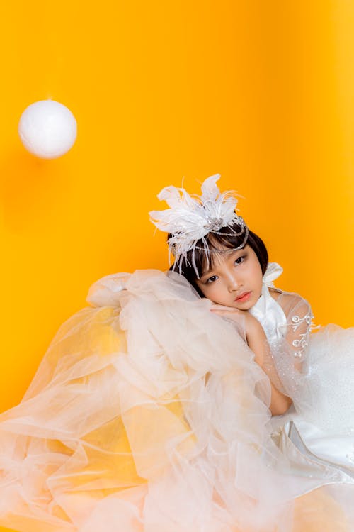 Tender girl in costume on yellow background · Free Stock Photo
