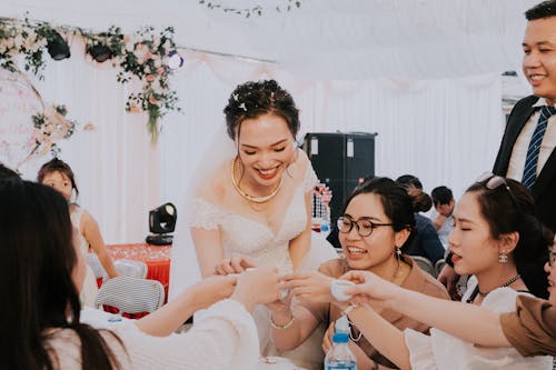 Happy newlyweds toasting with guests