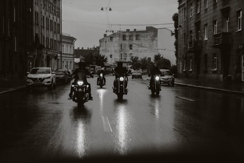 Free People Riding Motorcycles on the Wet Road Stock Photo
