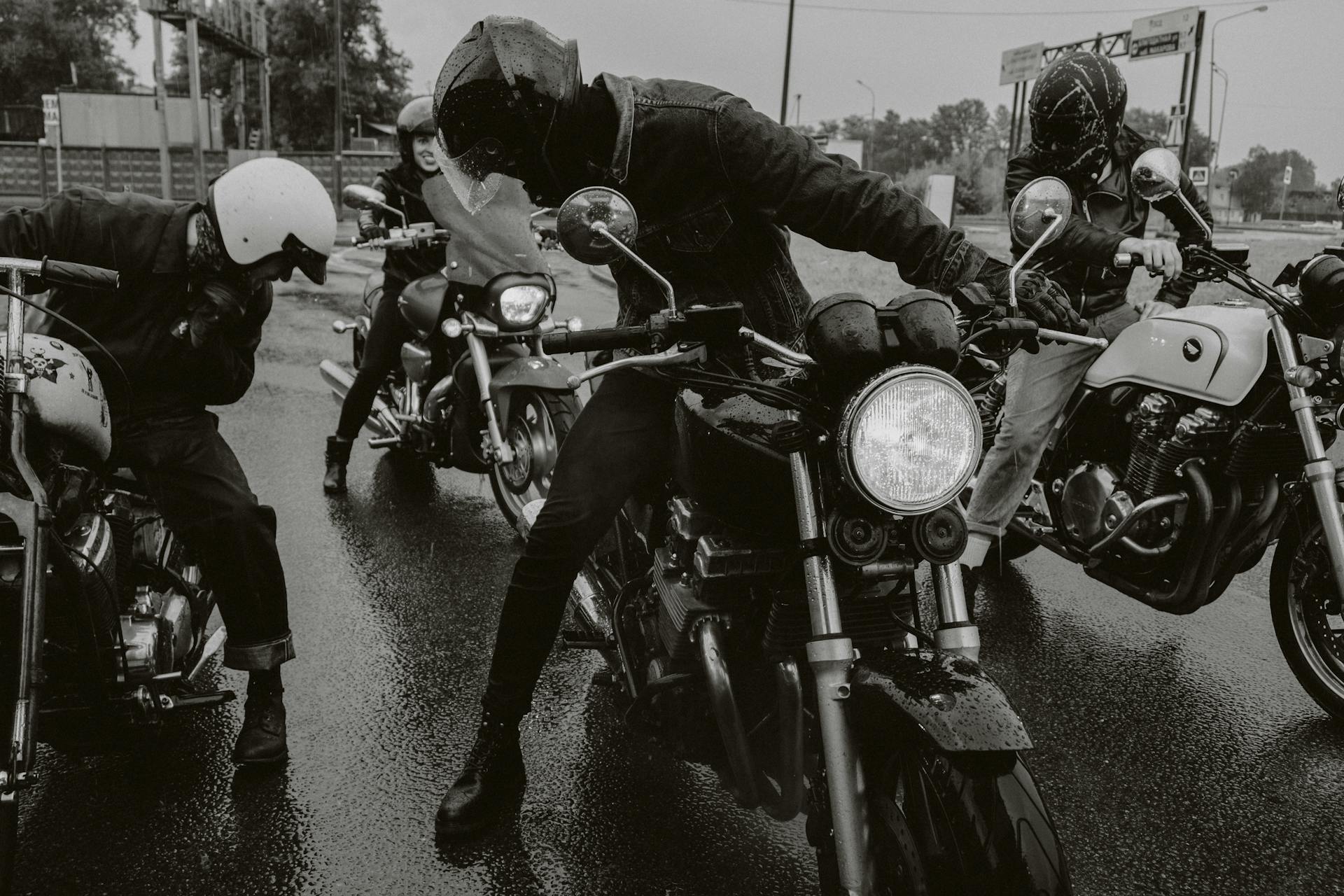 Group of motorcyclists riding on a wet street showcasing dynamic and adventurous vibe.