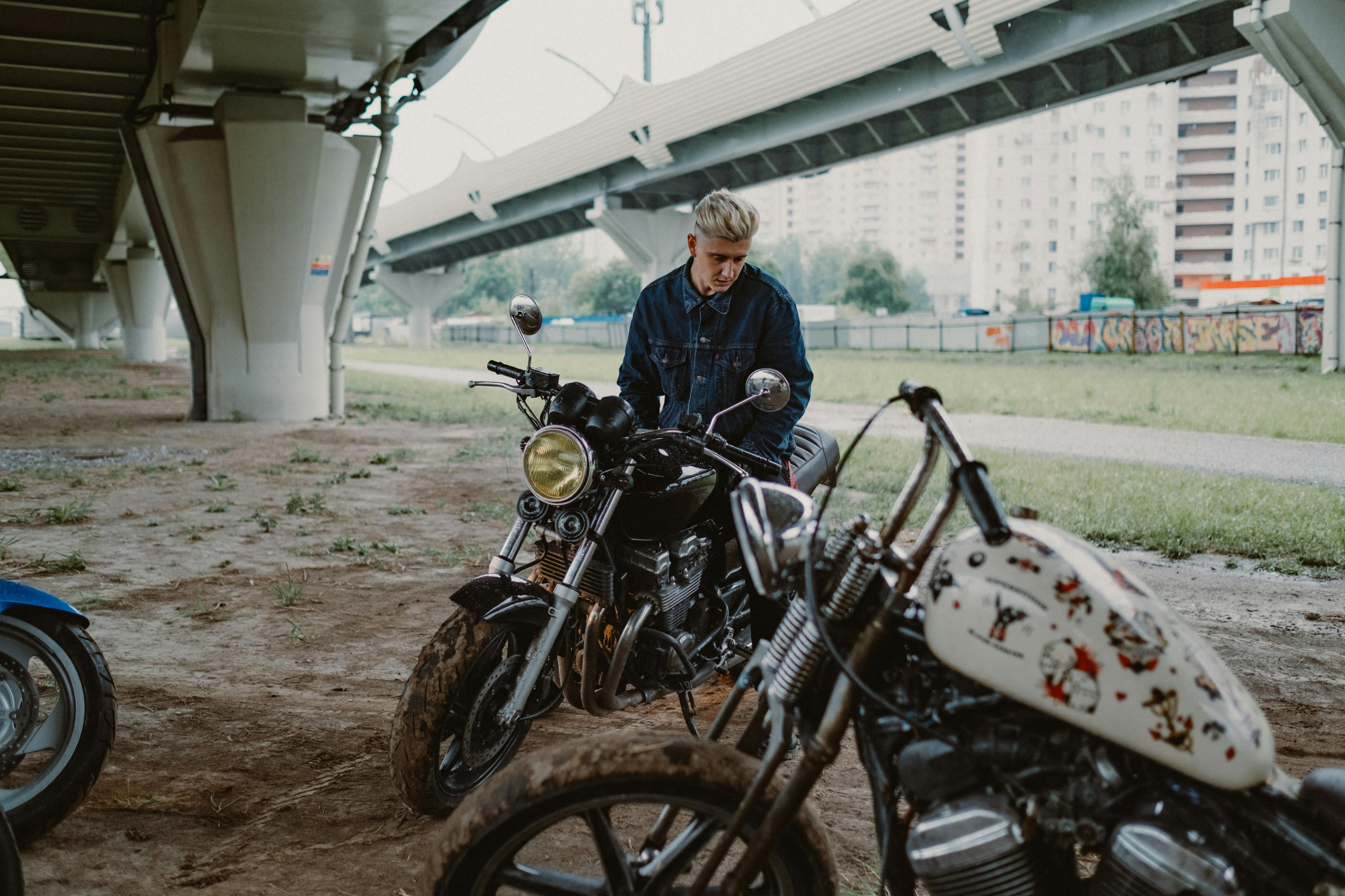 a man with two motorcycles