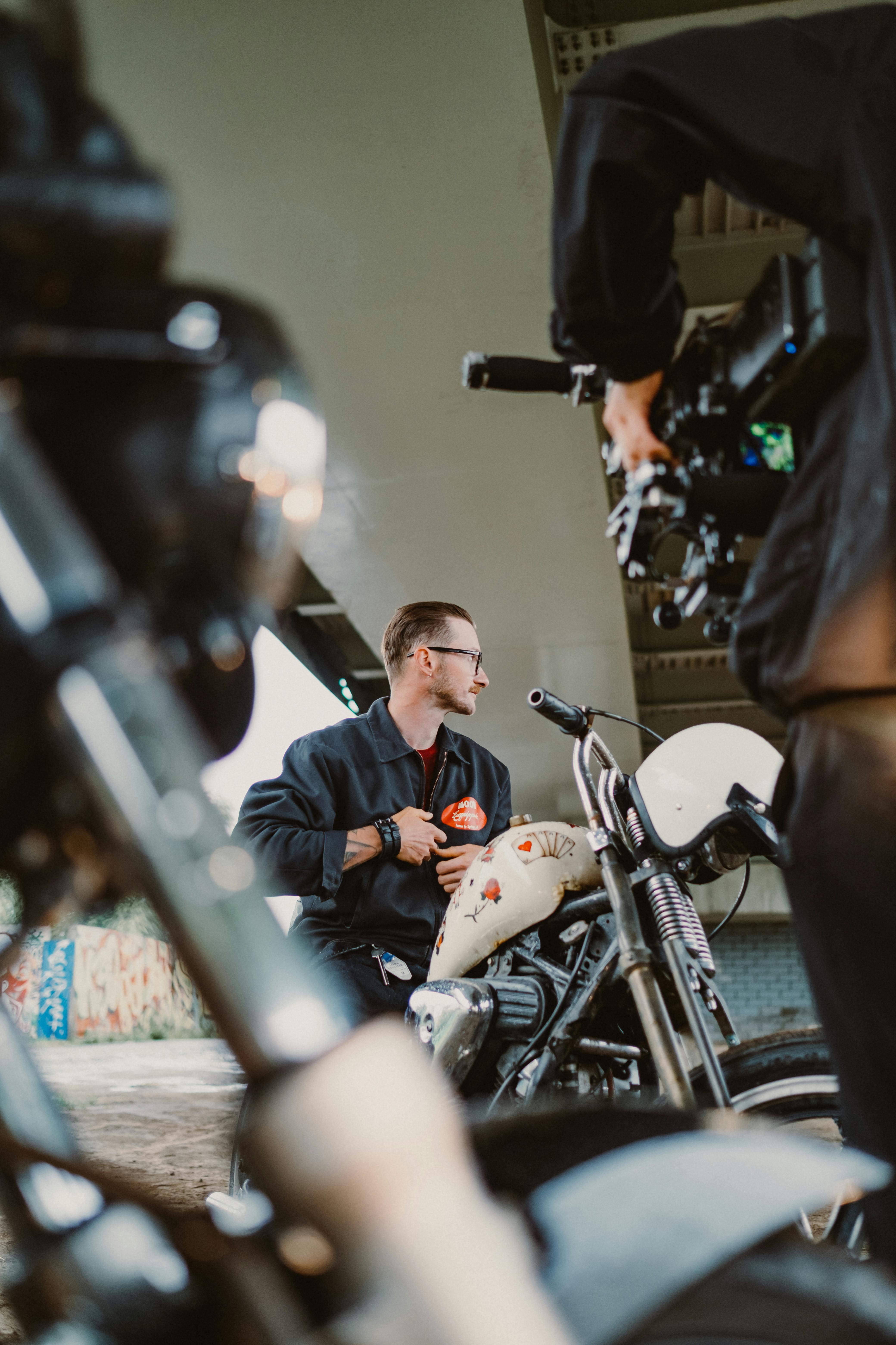 man in black jacket sitting on motorcycle