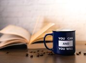 Motivational mug with an open book and coffee beans, perfect for inspiring your day.