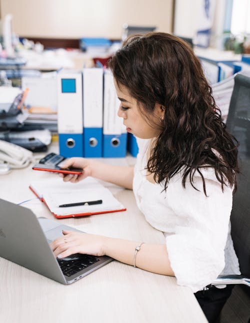 Woman Working in the Office Using Laptop 