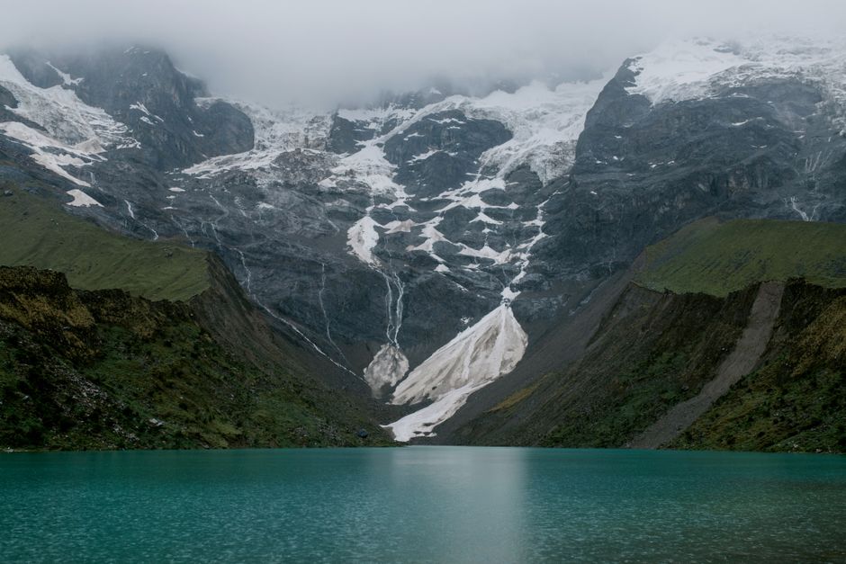 Best Iquitos: 5 Days Jungle Amazon - All Included Review 2026 - Serene view of the snow-capped Andes Mountains reflected in a turquoise lake in Peru.