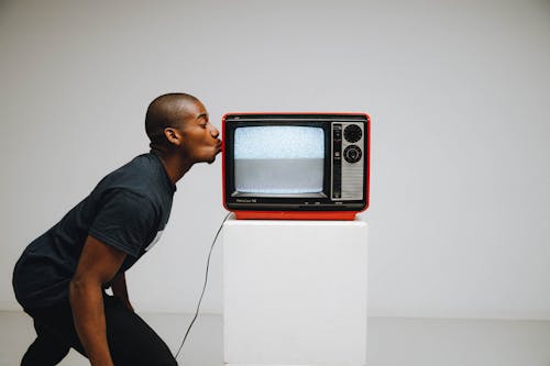 Photo Of A Man Kissing A Television