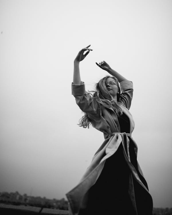 Grayscale Photo of Woman Dancing