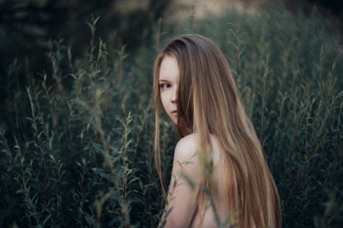 Topless Woman in the Middle of Green Grass Field