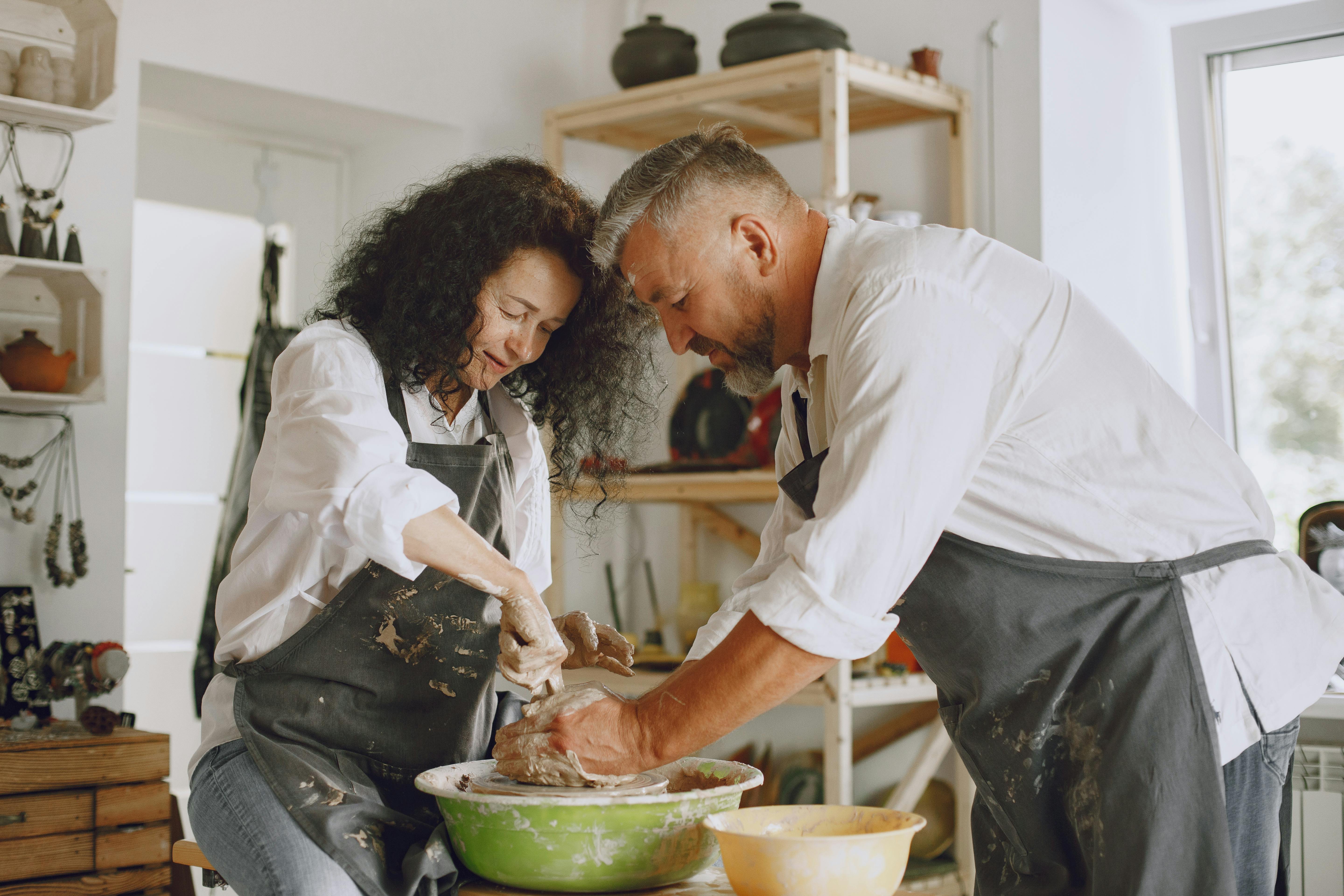 Free A couple enjoys pottery making in a cozy studio. Creative and intimate teamwork. Stock Photo