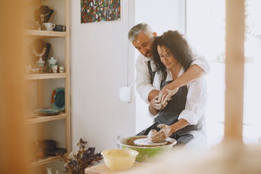 Couple Wearing Aprons Doing Pottery
