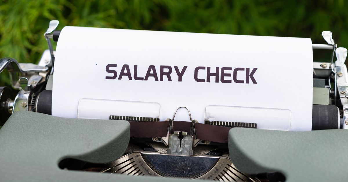 Salary Threshold for Skilled Worker Visa UK: 2025–2026 Rules Explained — Close-up of a vintage typewriter typing 'Salary Check' on paper, symbolizing payroll and finance.
