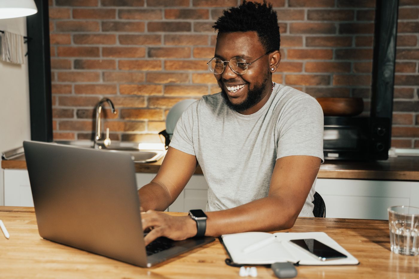 African professional working remotely on laptop
