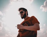 Man in Red Crew Neck T-shirt Wearing Black Sunglasses