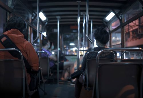 Free Passengers commute by bus in Hong Kong at night, showcasing urban public transportation. Stock Photo
