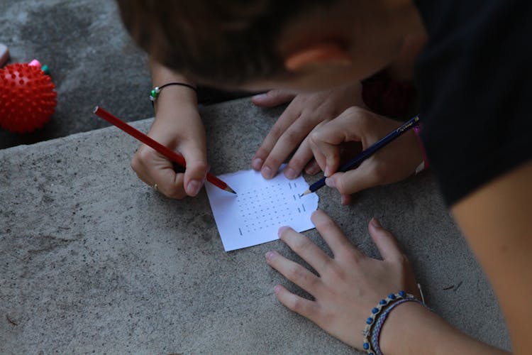 People Solving A Word Puzzle