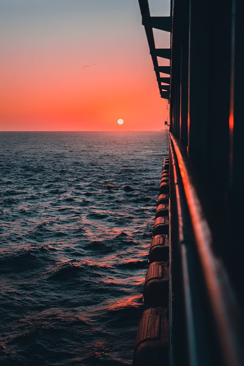 Free Blue Sea Under Orange Sky During Sunset Stock Photo