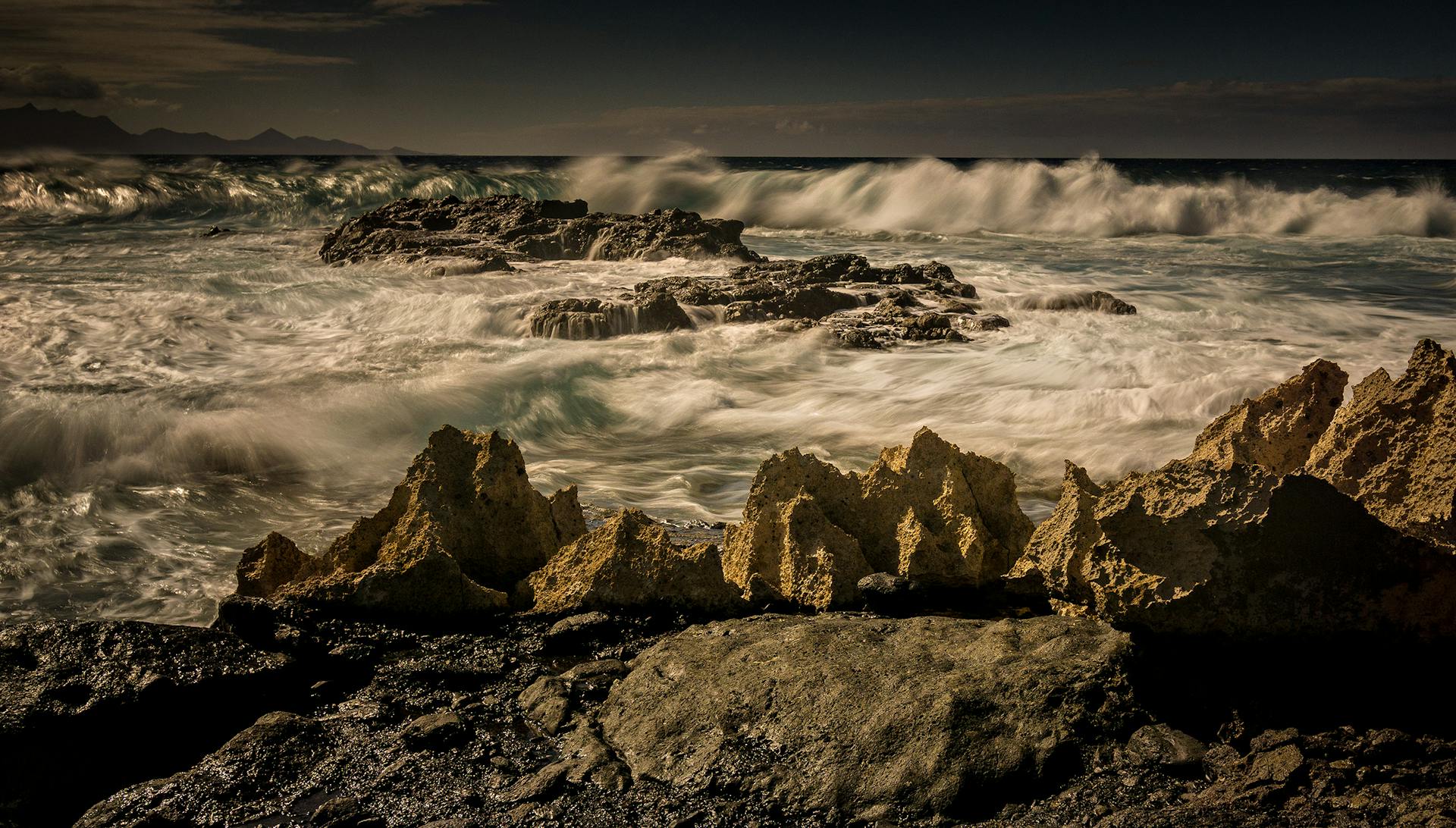 Experience the raw power of nature with dramatic waves crashing against rocky coastlines, creating a breathtaking seascape.