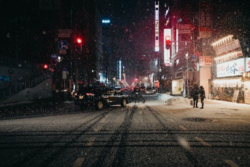 Free Snowing on a Busy Road During Night Time Stock Photo