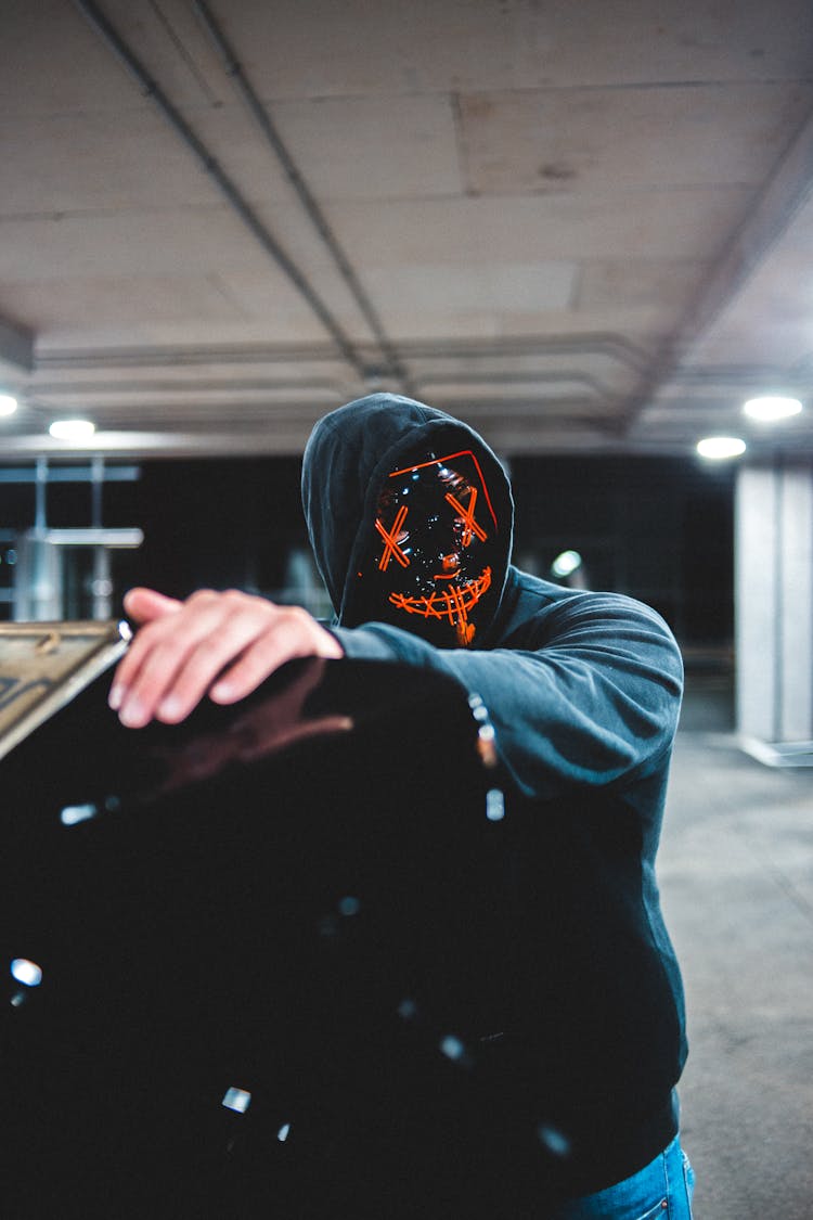 Anonymous Man In Mask In Parking Lot