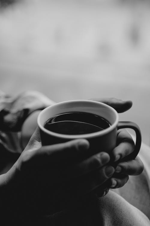 Free A Person Holding a Cup of Coffee Stock Photo