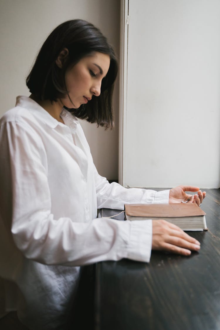 Woman Looking At A Bible