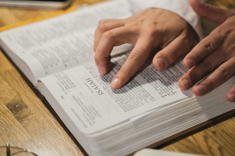 Person Reading A Holy Bible