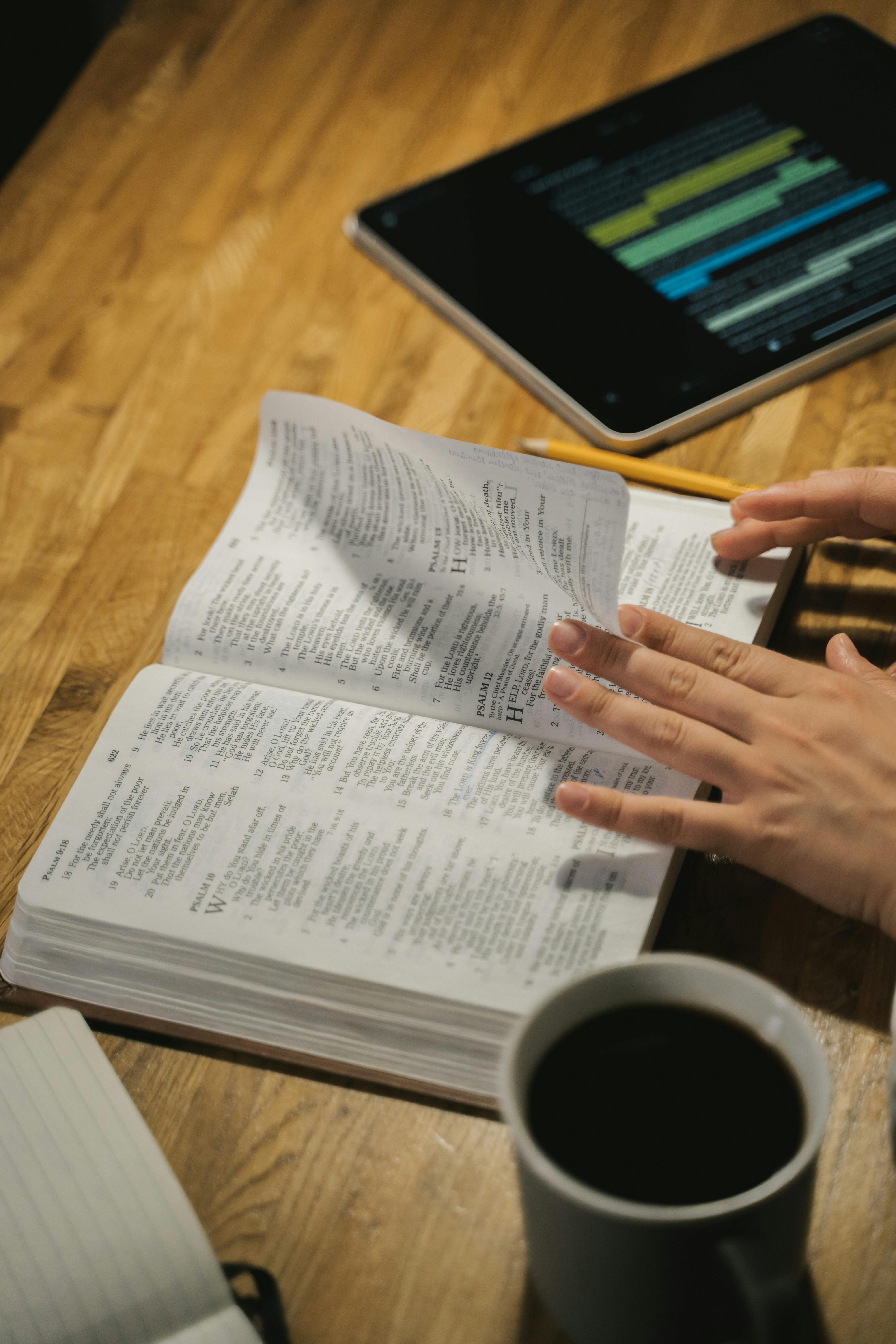 person turning a page of a book