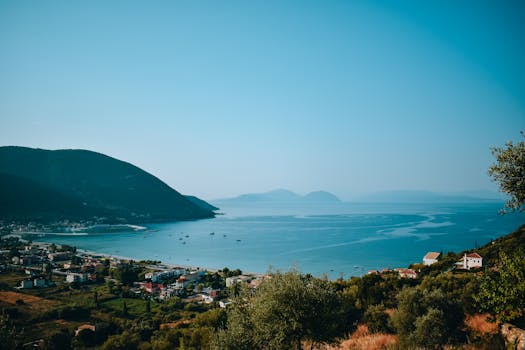 Breathtaking view of a serene coastal area with mountains and clear blue sea.