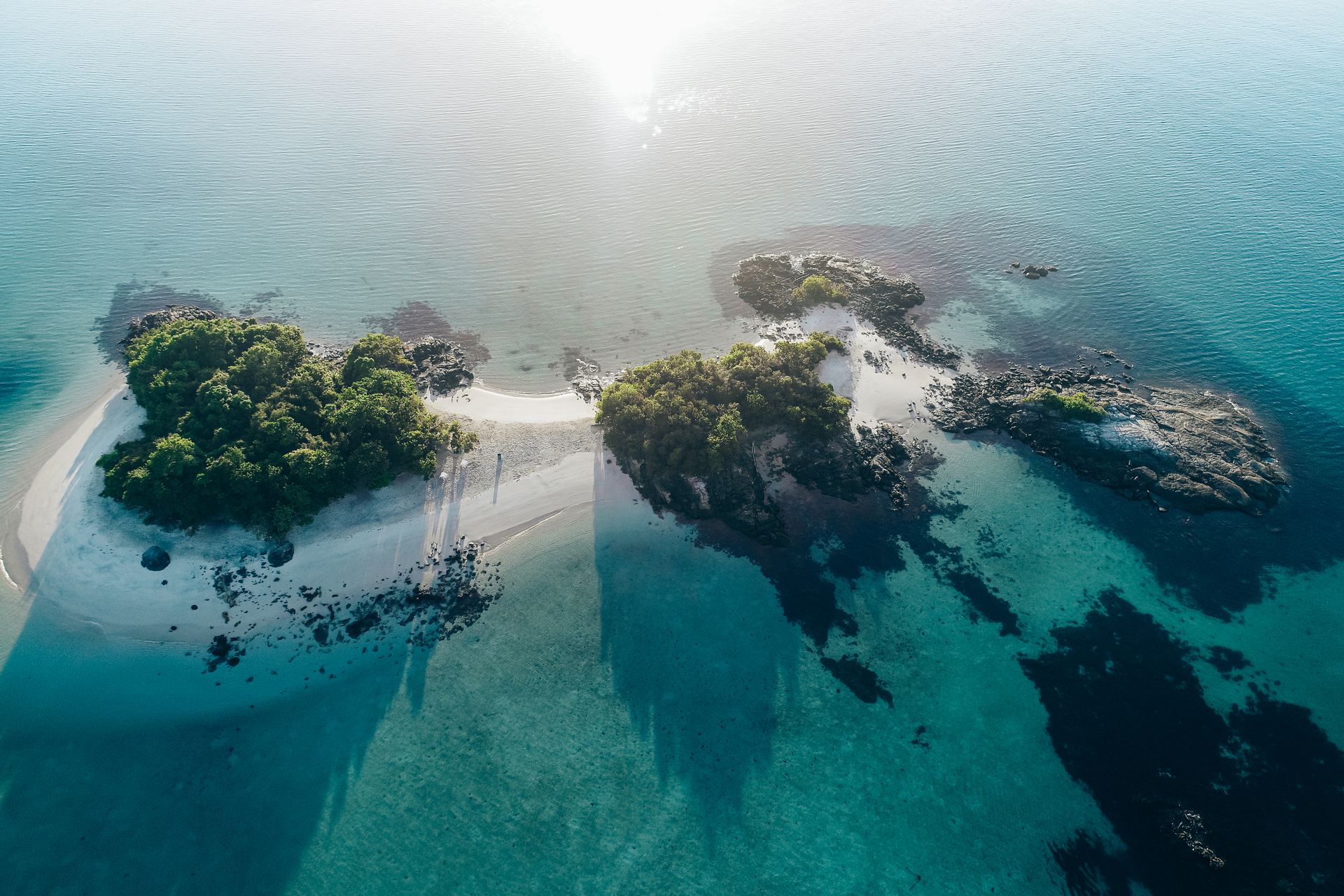Explore a breathtaking aerial view of a lush island in Brazil surrounded by crystal-clear waters.