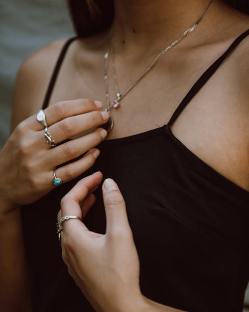 Free Young woman showing accessories on hands and neck Stock Photo