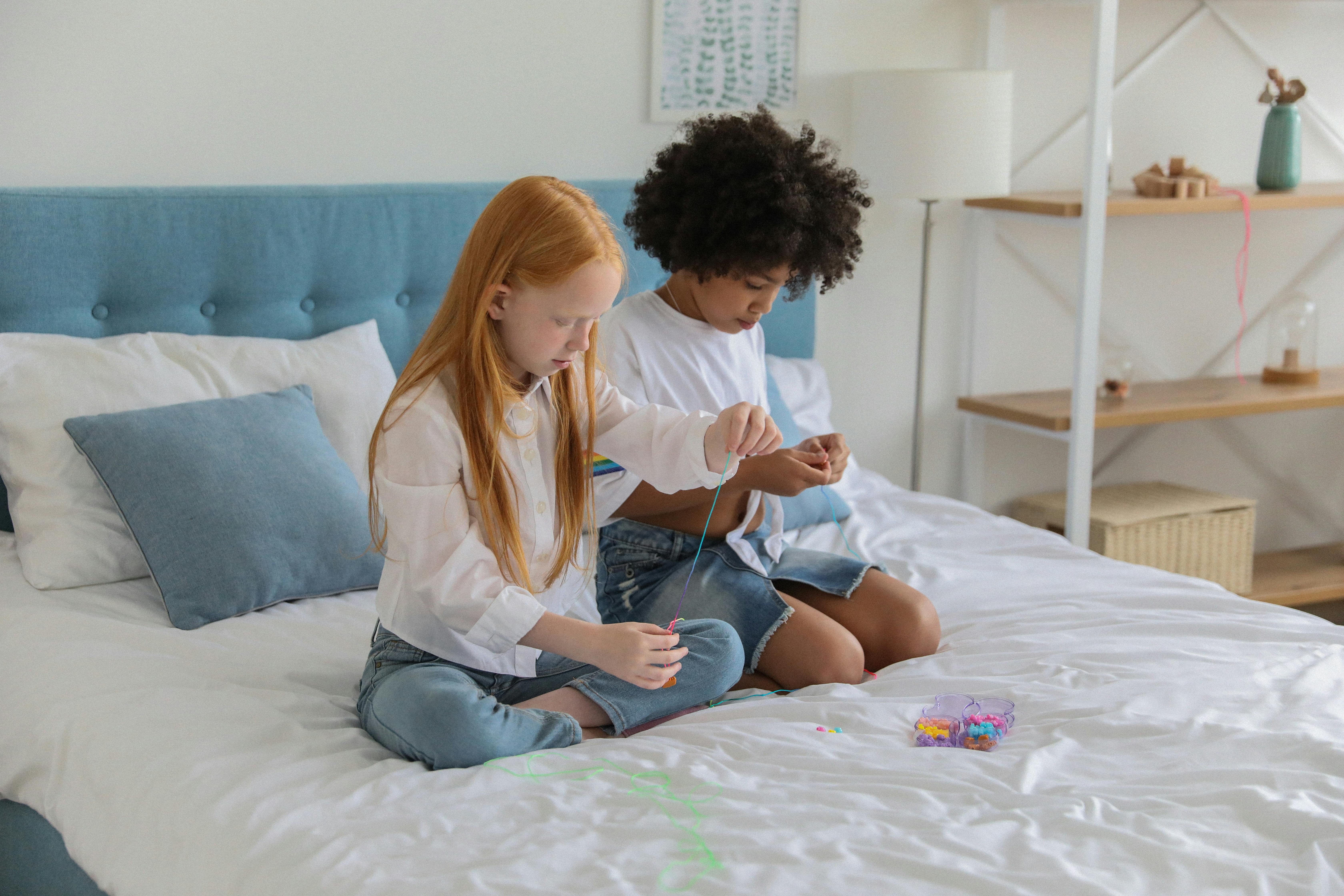 multiracial girlfriends with beads on soft bed