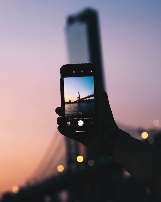 A stunning smartphone shot of New York City skyline and bridge at twilight, capturing a serene moment.