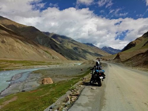 Free A motorcyclist enjoys the scenic view of mountains and river in Lahaul and Spiti, India. Stock Photo