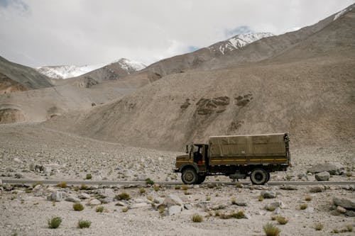 Truck riding on road in mountainous terrain