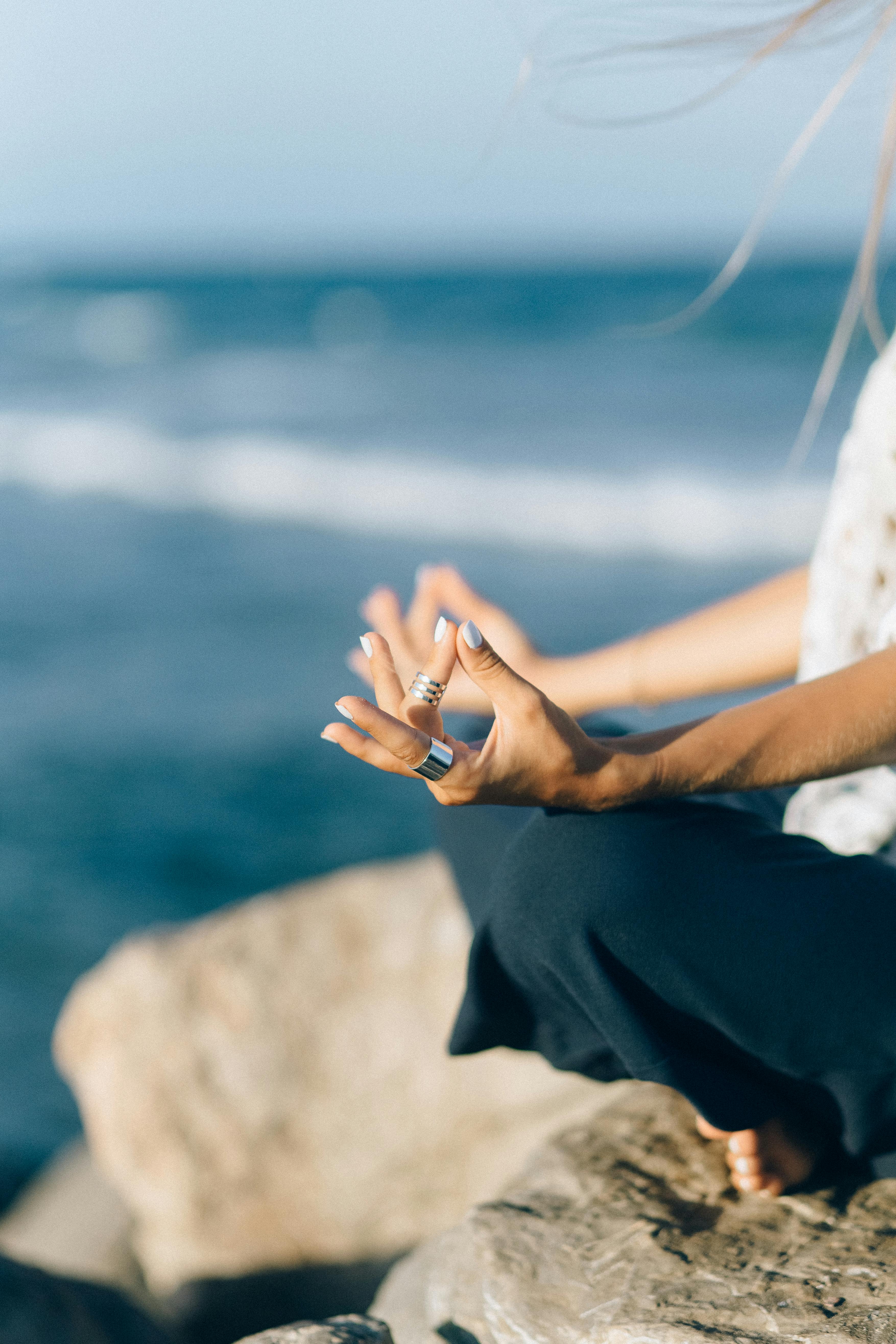Person practicing advanced breathing technique in natural setting