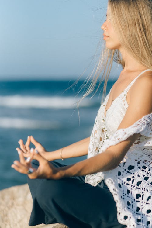 A Woman Meditating Near Sea