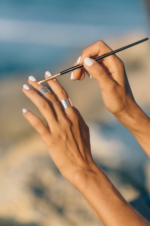 Close Up Shot of Hands Holding Paint Brush