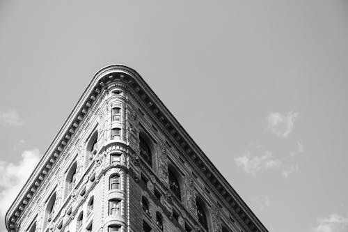 A Grayscale of The Flatiron Building under a Clear Sky