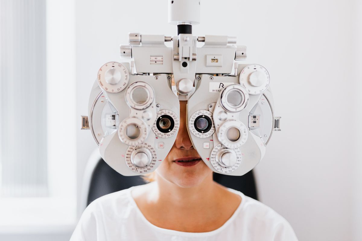 Person undergoing an eye exam with a phoropter