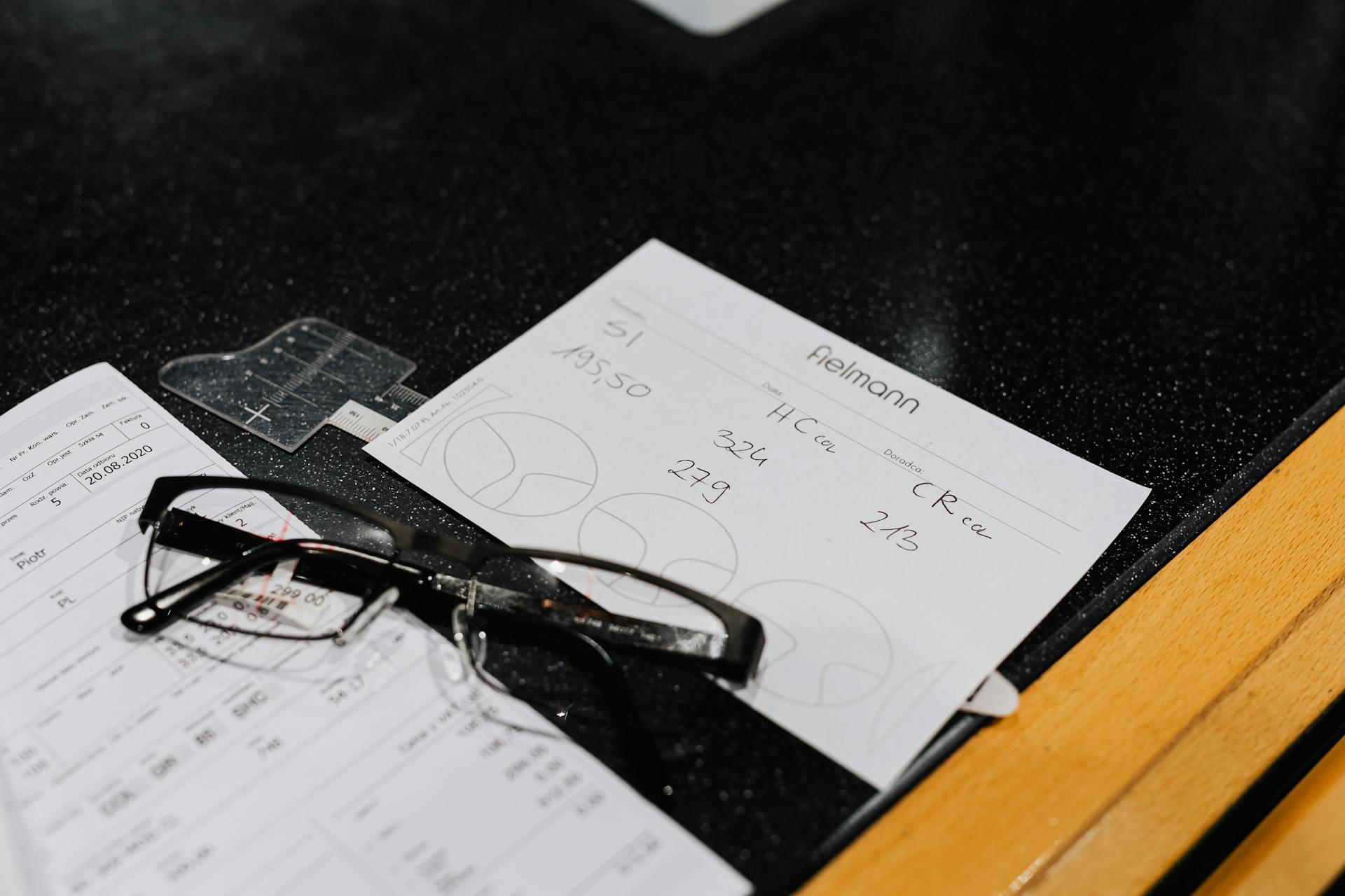 Medical Prescription Beside the Eyeglasses on a Black Surface