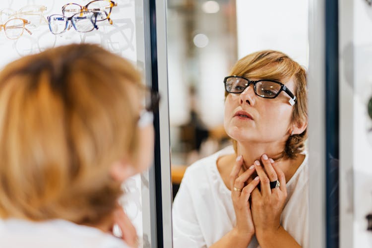 Woman Looking At A Mirror