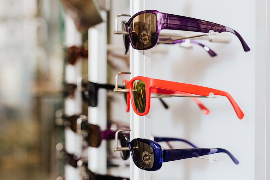 Optometrist assisting customer in stylish eyewear store with modern fixtures