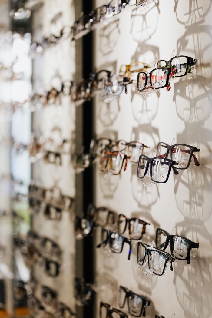 Opticien aidant une cliente à choisir des lunettes