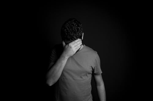 Free Man Hiding His Eyes with Hand Stock Photo