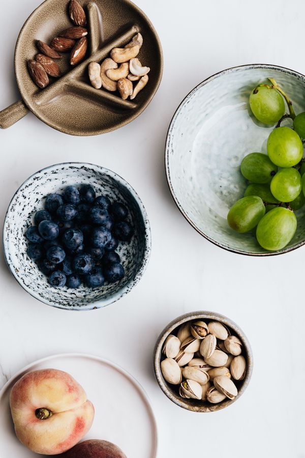Bowls of nuts, blueberries and fresh fruit