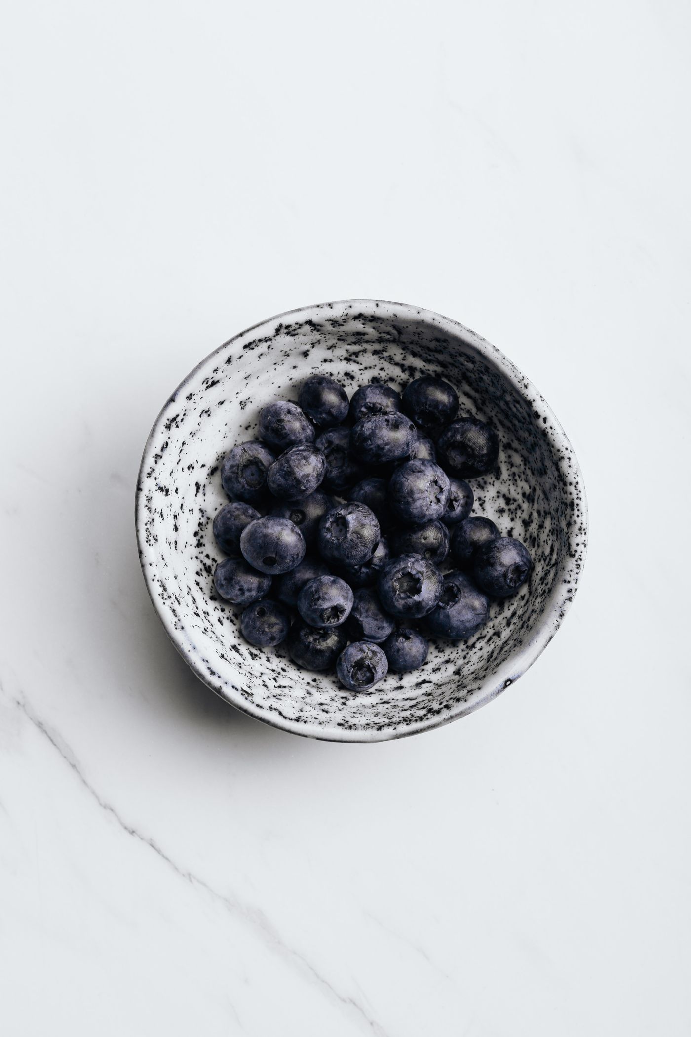 Blueberries piled in a ceramic bowl