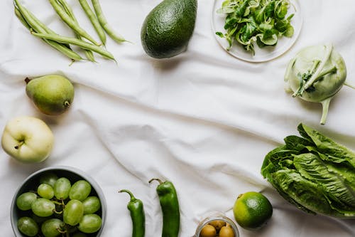 Green Vegetables and Fruits on a White Surface